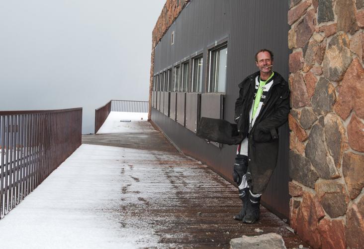 Two motorcyclists share quiet moment in honor of deceased after reaching peak