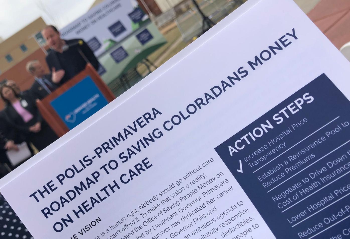 Polis unfolds ‘roadmap’ for cutting health-care costs