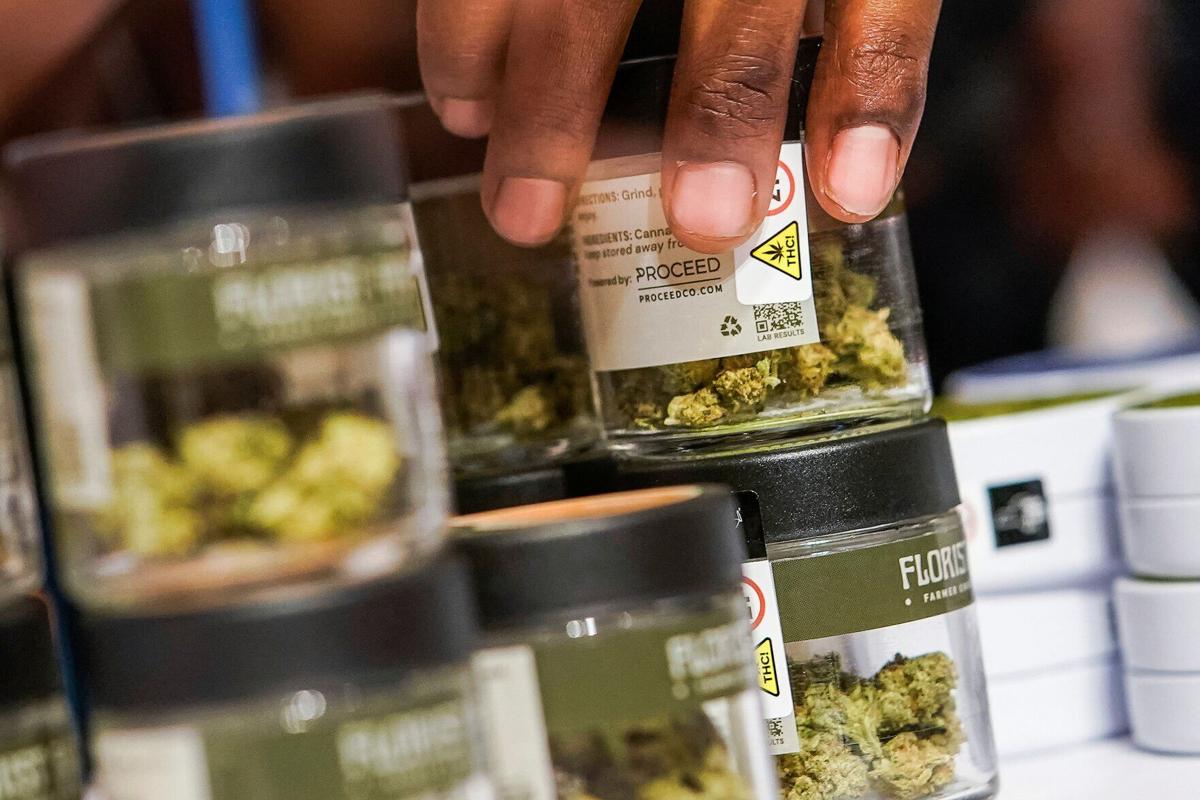 A worker organizes cannabis flowers before the opening of the first legal recreational marijuana dispensary located in the East Village in the Manhattan borough of New York City on Dec. 29, 2022. (copy)