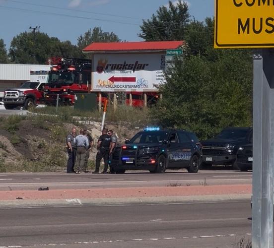 Law enforcement sweep car on East Platte Avenue after report of bomb