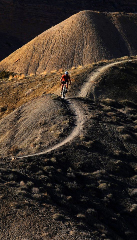 A mountain biker races through the rolling turns on Joe's Ridge Sunday, March 31, 2013, in the Bookcliffs/18 Road area north of Fruita. Colo. (The Gazette, Christian Murdock)