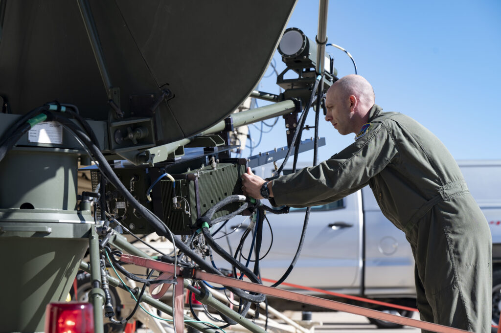 A man works on an antenna. 