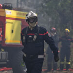A firefighter works during a wildfire at the region of the historic Fontainebleau forest, about 60 km (37 miles) south of Paris, France, Monday, July 13, 2026. (AP Photo/Emma Da Silva)