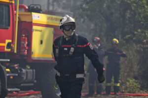 A firefighter works during a wildfire at the region of the historic Fontainebleau forest, about 60 km (37 miles) south of Paris, France, Monday, July 13, 2026. (AP Photo/Emma Da Silva)