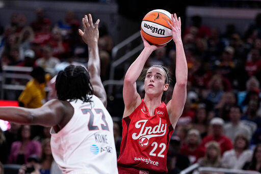 Indiana Fever guard Caitlin Clark (22) shoots over Atlanta Dream forward Sika Kone (23) in the first half of a WNBA basketball game in Indianapolis, Thursday, June 18, 2026. (AP Photo/Michael Conroy)